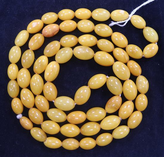 A single strand oval amber bead necklace, 92cm.